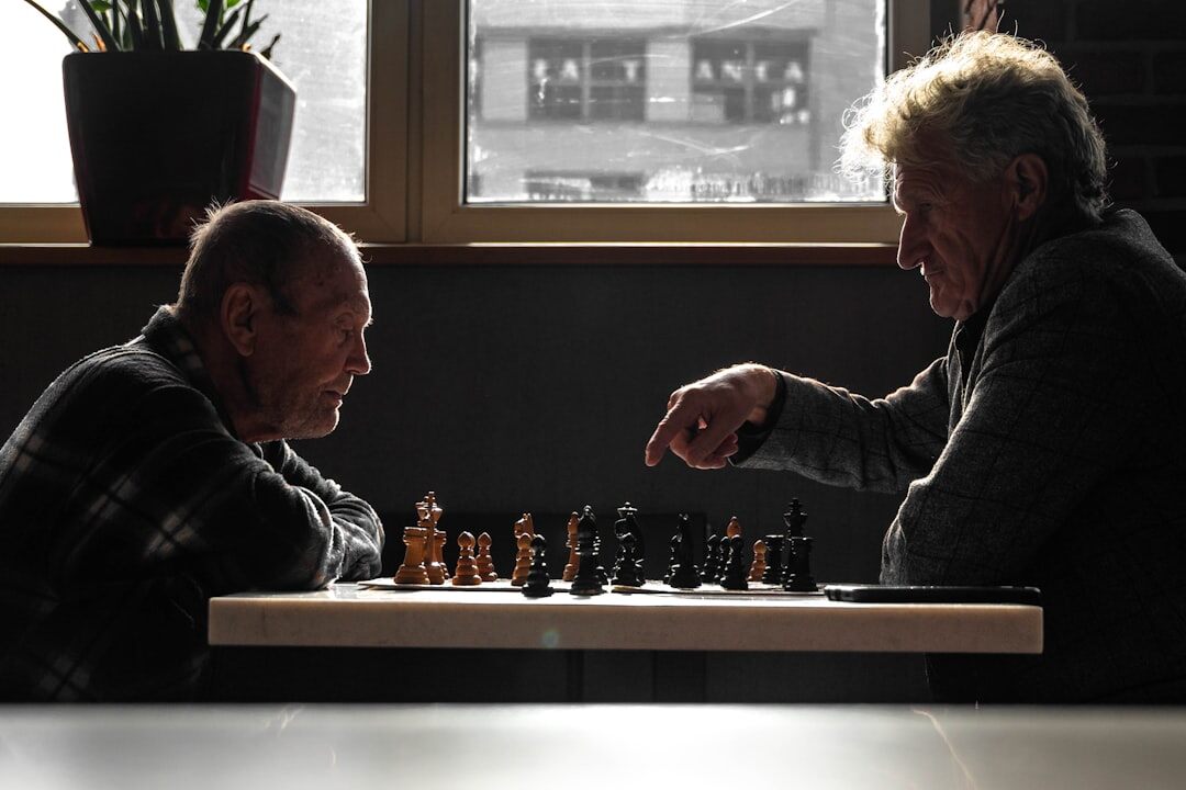 Seniors playing chess at a club table
