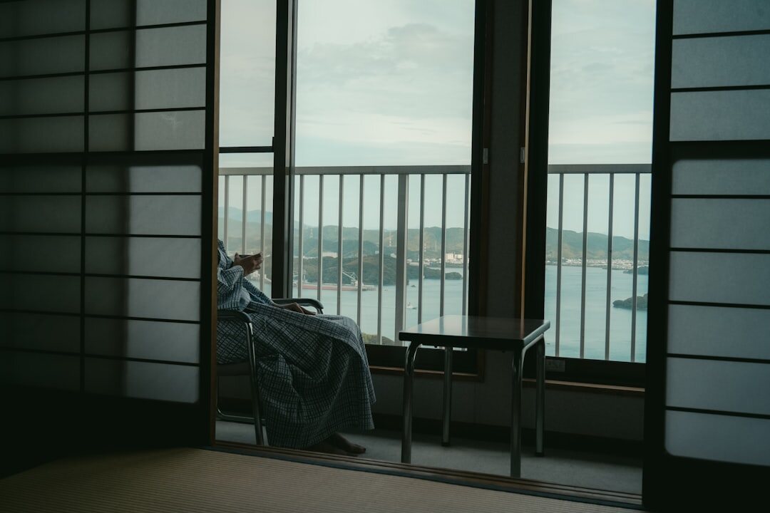 elderly woman drinking tea on balcony
