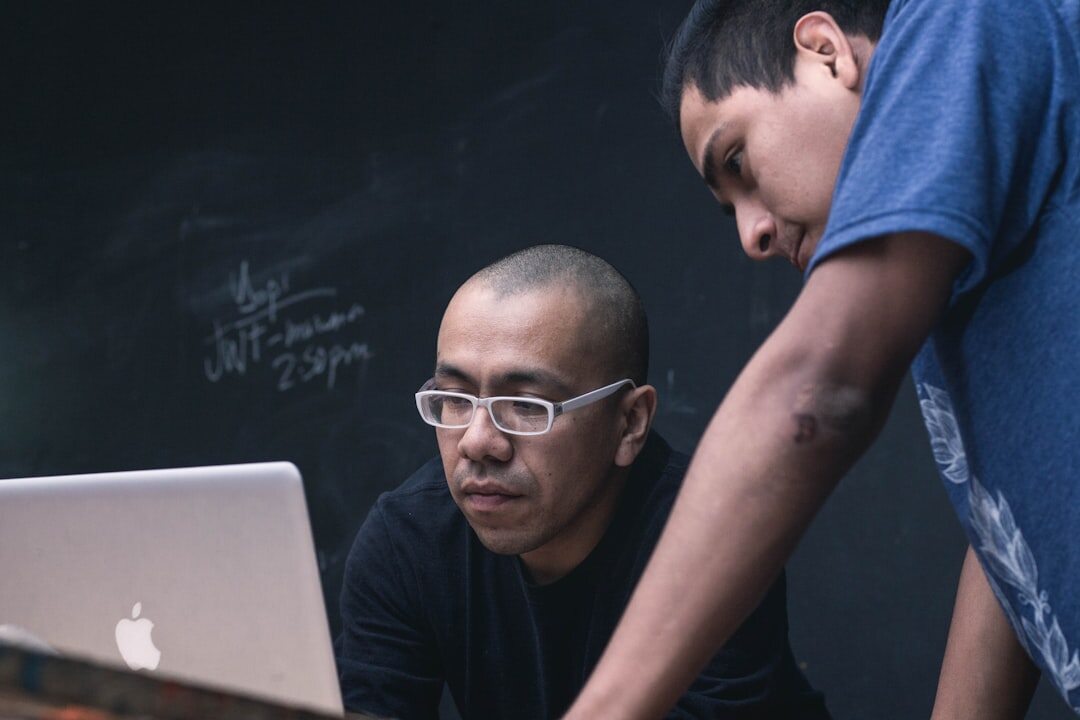 Senior citizens learning computer skills in a classroom with a tutor