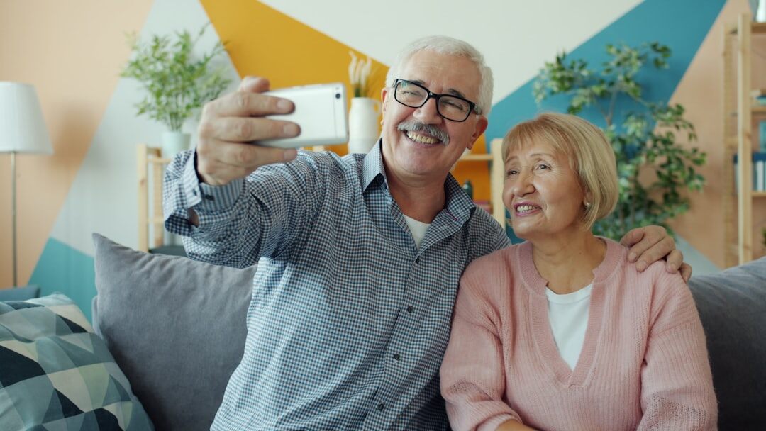 Senior couple smiling while shopping with a discount card
