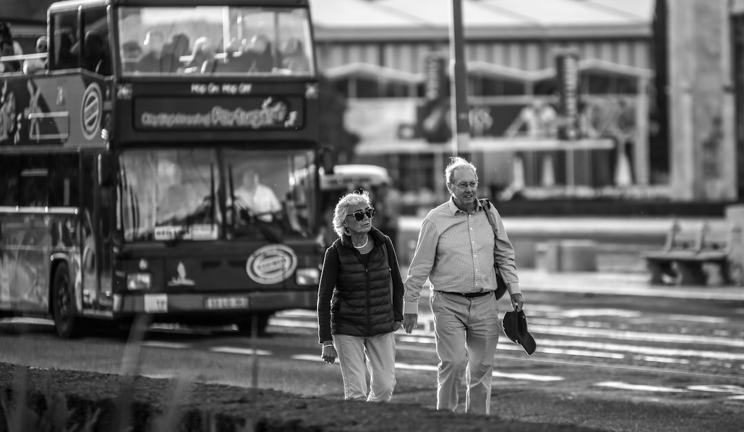 Seniors on a bus trip sightseeing a historic castle